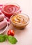 Bowls with ketchup and dijon mustard close-up and milk sausages on a background