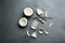 Bowls of natural organic oil and coconuts on grey stone background