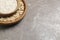 Bowls with oat flour and flakes on grey background.