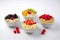 Bowls of oatmeal with berries and fruits on white background. Generative AI