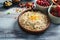 Bowls with oatmeal flakes and berries on wooden table