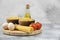 Bowls of raw pasta, eggs, tomatoes and olive oil on marble surface