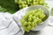 Bowls with ripe juicy grapes on light table