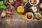 Bowls and spoon of Various spices selection on rustic wooden background, top view