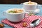 Bowls with tasty creamy soup of parsnip served on light blue wooden table, closeup