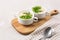 Bowls with tasty creamy soup of parsnip served on light grey background