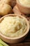 Bowls of tasty mashed potato, pepper and leeks on wooden table, closeup