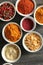 Bowls with various spices on wooden background