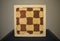 Box with abstract chess like drawings on plush table