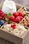 Box with breakfast items - oatmeal, muesli, nuts, berries