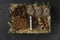 Box with chocolate and sweets on dark grey table, top view