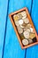box with coins of countries of the world on a blue wooden background. money.a Palestinian coin, a Soviet coin, an Israeli