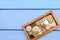 box with coins of countries of the world on a blue wooden background. money.a Palestinian coin, a Soviet coin, an Israeli