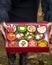 Box of colorful yummy Christmas cupcakes with different decorations