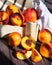 A box of delicious fresh peaches on the table. Peaches in an old rustic box on a dark wooden table.