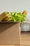 Box filled with food on an isolated background. In the box are vegetables, fruits, bananas, fresh salad, spaghetti. Concept of