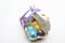 Box full of Easter eggs corded with lilac ribbon on white background with copy space for text.