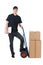 Box moving. Cheerful young deliveryman leaning on the cart with