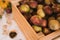 A box of rustic sweet apples on a table at home. Autumn still life