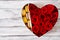 Box in the shape of a heart with red roses and macaroon. Gift on Valentine\'s Day.