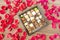 Box of tasty chocolates among rose petals - a romantic gift