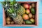 Box of tropical fruits in market crate on market table