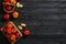 Box and wicker basket with ripe tasty apples on dark wooden background