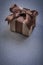 Boxed gift with brown tape on grey background celebrations conce