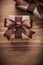 Boxed gift containers with brown ribbons on vintage wooden board