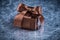 Boxed gift with tied bow on metallic background holiday concept