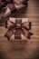 Boxed present containers with brown ribbons on vintage wooden bo