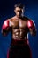 Boxer Boxing staring showing strength. Young man looking aggressive with boxing gloves.