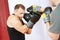 Boxer man at boxing training with punch mitts