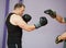 Boxer man at boxing training with punch mitts