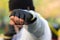 Boxer man strikes with his fist in a protective glove at the target. In his fist clamped with great rubber from the trainer