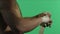 Boxer pulls bandage before the fight or training. Fighter pulls the bandages on green background