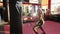 Boxer punch. Kickboxing black man training punching bag in fitness studio.