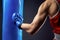 Boxer`s hand in a blue boxing glove. A boxer strikes a punching bag