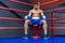 Boxer sitting in boxing ring