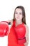 Boxer woman during boxing exercise making direct hit with red glove