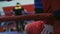 Boxers during break in the ring. Silhouettes of athletes in the red and blue ring. Helpers who organize rest for