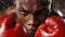 A boxers face is contorted in a mixture of determination and pain as he pushes through exhaustion
