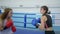 Boxers in gloved training and fighting together on ring in sports club