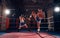 Boxers training kickboxing in the ring at the health club