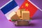 Boxes in a food basket and flags of China and France on a colored background, the concept of trade between countries