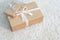 Boxes tied with white tape of different sizes lie on the rug. Holiday, delivery, gifts, surprise. Golden paper