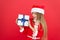 Boxing day. Cheerful kid red background. Advent calendar. Surprise her. Happy winter holidays. Small girl opening gift