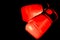 Boxing glove in Red in punching  in black background with copy space