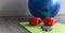 Boxing gloves, heavy grip and fitness ball in sport gym with copy space. Composition of different sportive objects on mat. healthy