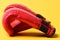 Boxing gloves in red color on yellow background.